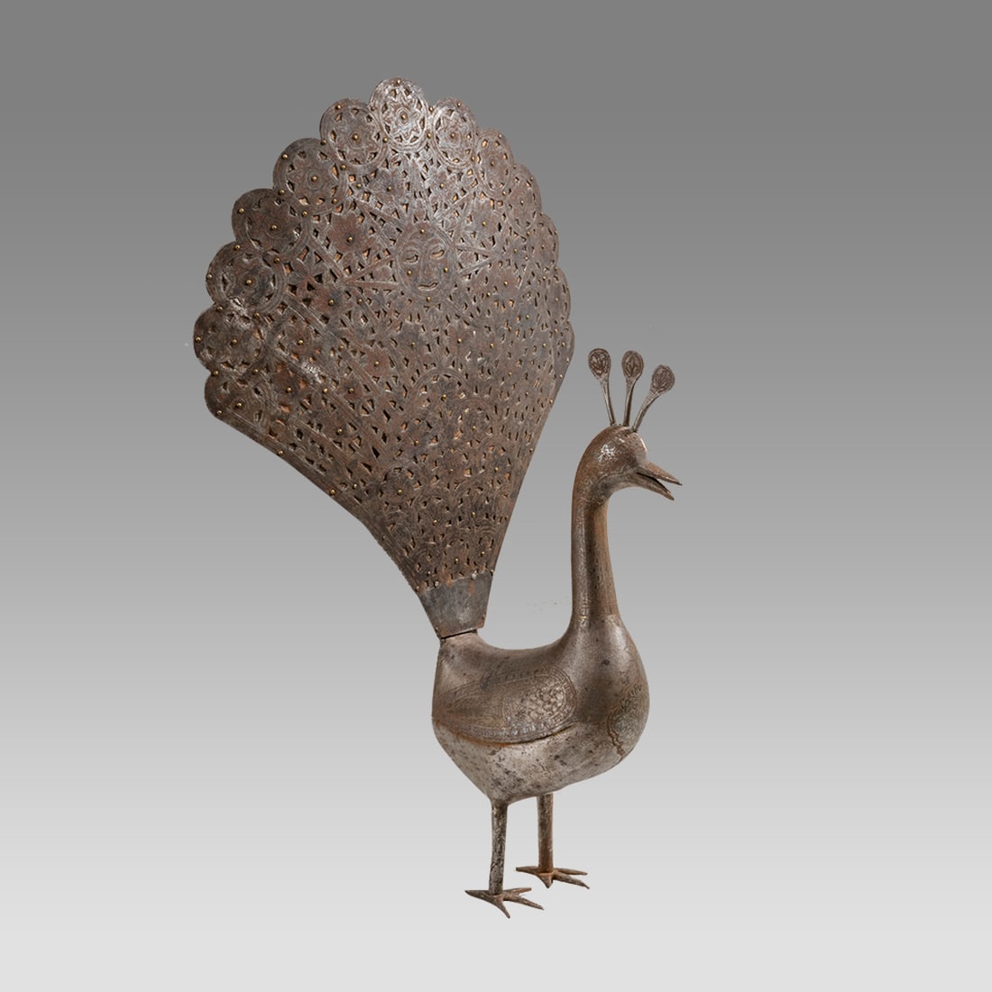 19th century Islamic Persian Qajar Steel peacock.: 19th century Islamic Persian Qajar Steel peacock. Size 20 3/4 inches high. 13 inches widest point. Large steel peacock decorated with engraved floral design. From Portland OR Estate.
