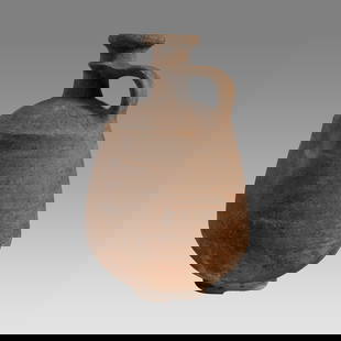 Ancient Holy Land Iron Age Pottery Jug c.1100 BC.: Ancient Holy Land Iron Age Pottery Jug c.1100 BC. Size 10 1/4 inches high. A large pottery jug with loop type strap handle with ring base. Provenance: From The estate of Rev. Boyce M. Bennett, THD,