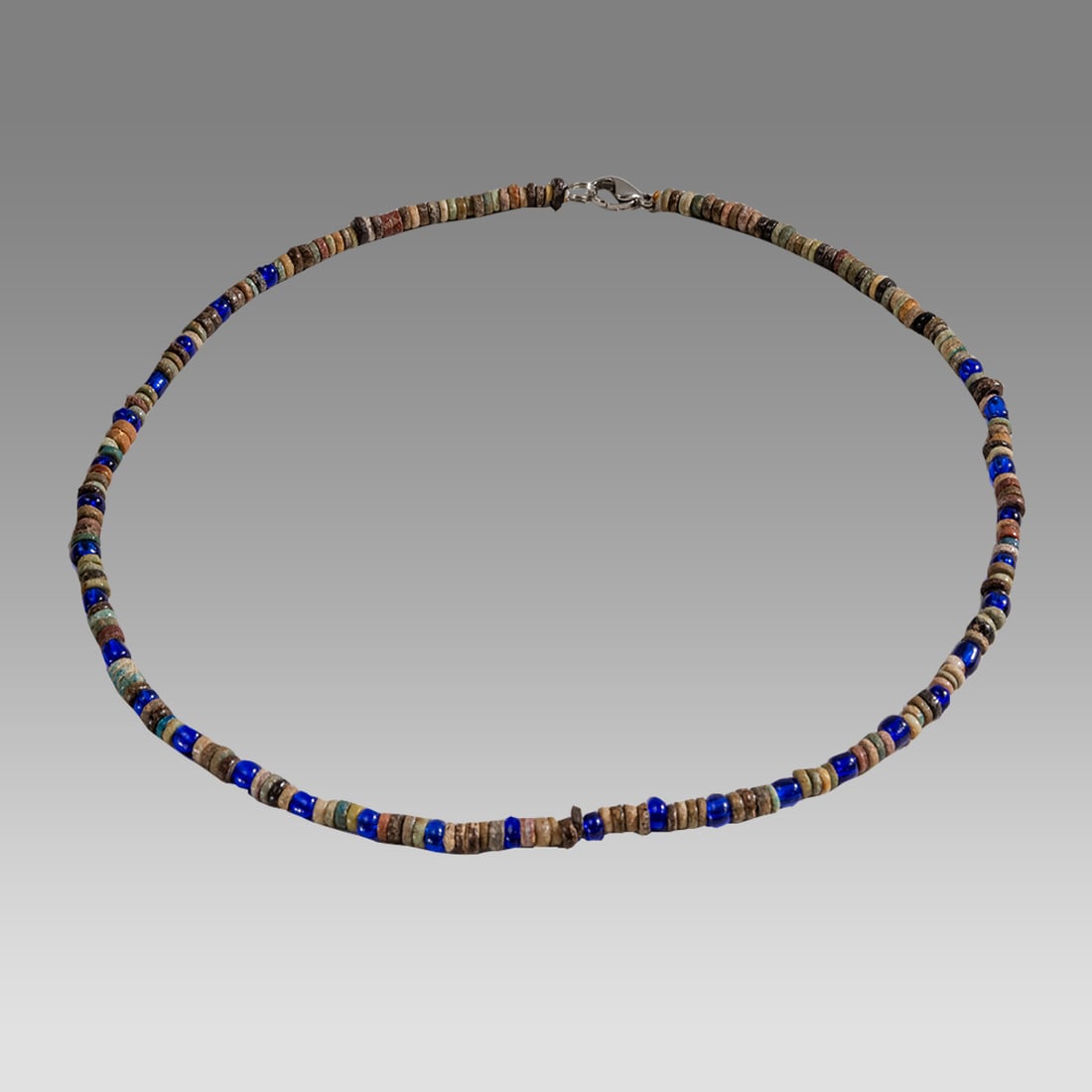 Ancient Egyptian Faience, bead Necklace c.300-50 BC.: Ancient Egyptian Faience, bead Necklace c.300-50 BC. Size 17 3/4 inches length. Great Looking single strand Faience Bead necklace mixed with modern blue glass beads. wearable. Provenance: Ex Secret Ey