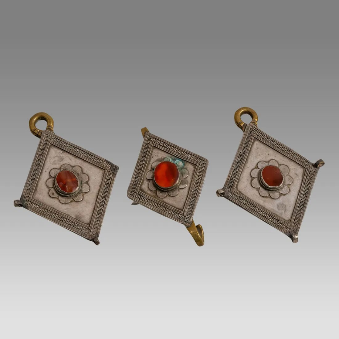 Lot of 3 Ersari Turkoman ornaments in good silver and brass with carnelian insets. (1 of 2)