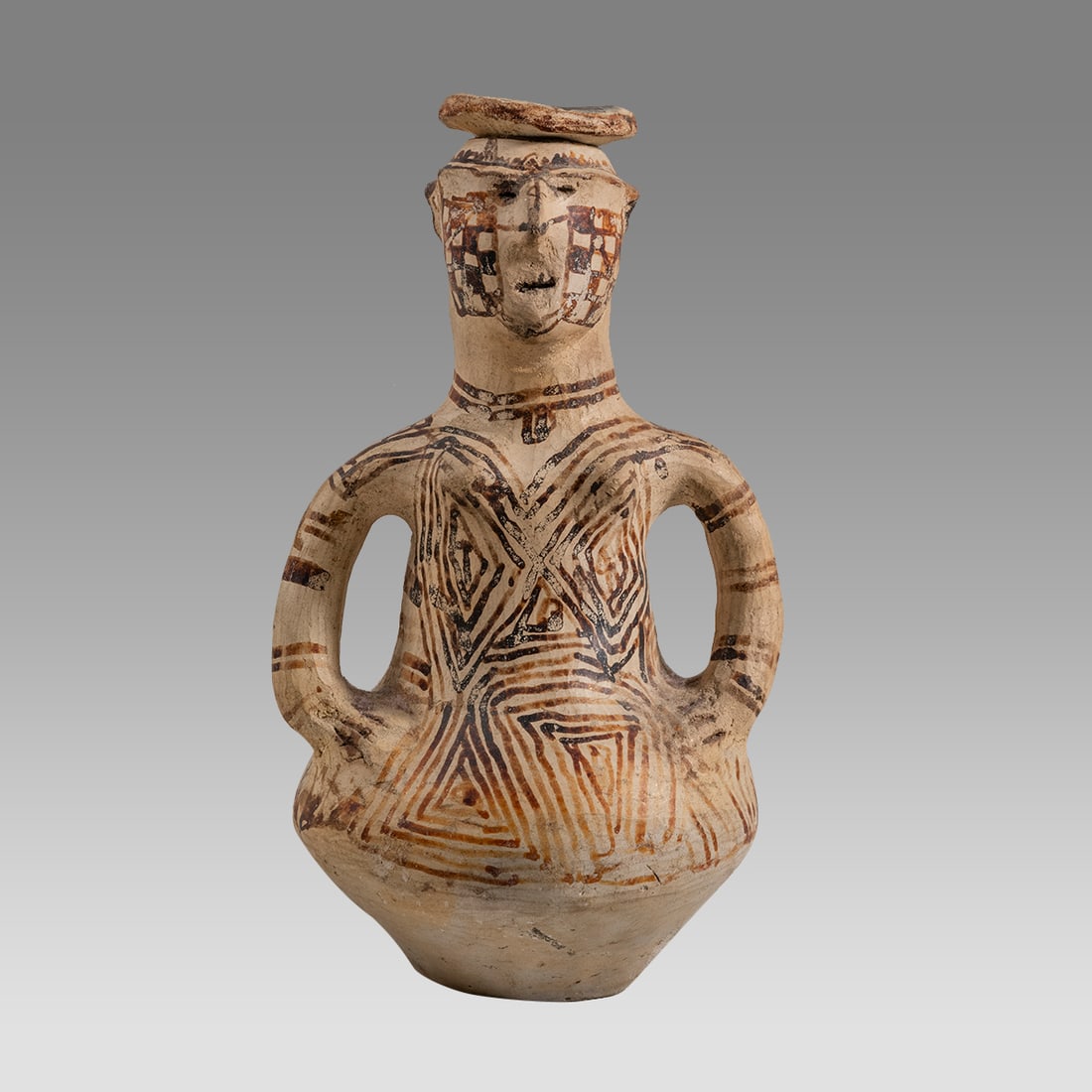 A Mojave Pottery Effigy Vessel with Lid.: A Mojave Pottery Effigy Vessel with Lid. Size 8 1/4 inches high. A pottery figural vessel of a woman with lid at top of head, decorated with geometric design. Provenance: acquired by Paul Lester Wiene