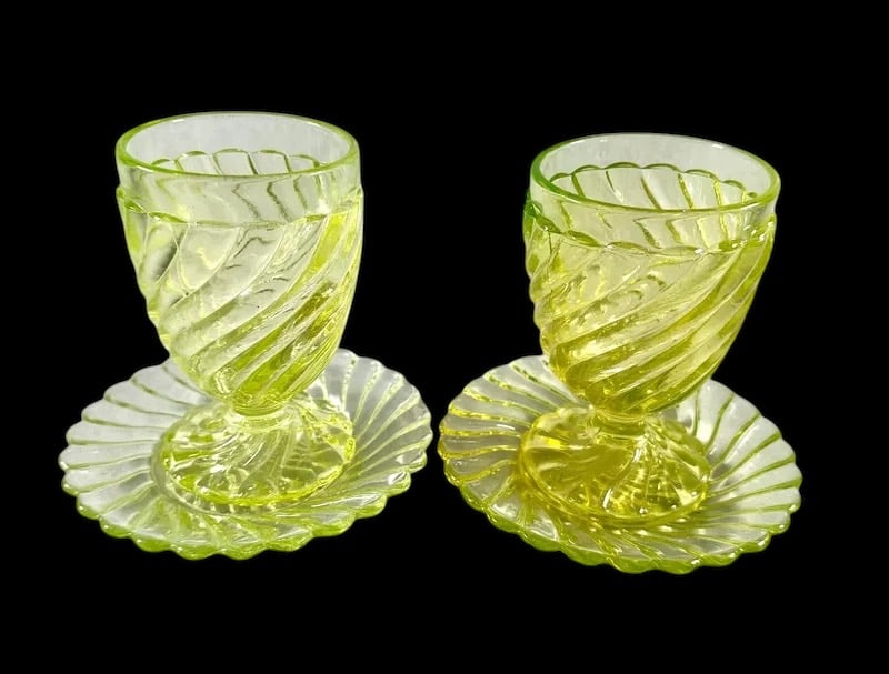 Pair of Antique French Baccarat Swirl Bambou Vaseline Uranium Goblets with Underplates: Pair of Antique French Baccarat Swirl Bambou Vaseline Uranium Goblets with Underplates. In excellent condition, they both glow under the black light, 5” tall by 5 ½” diameter