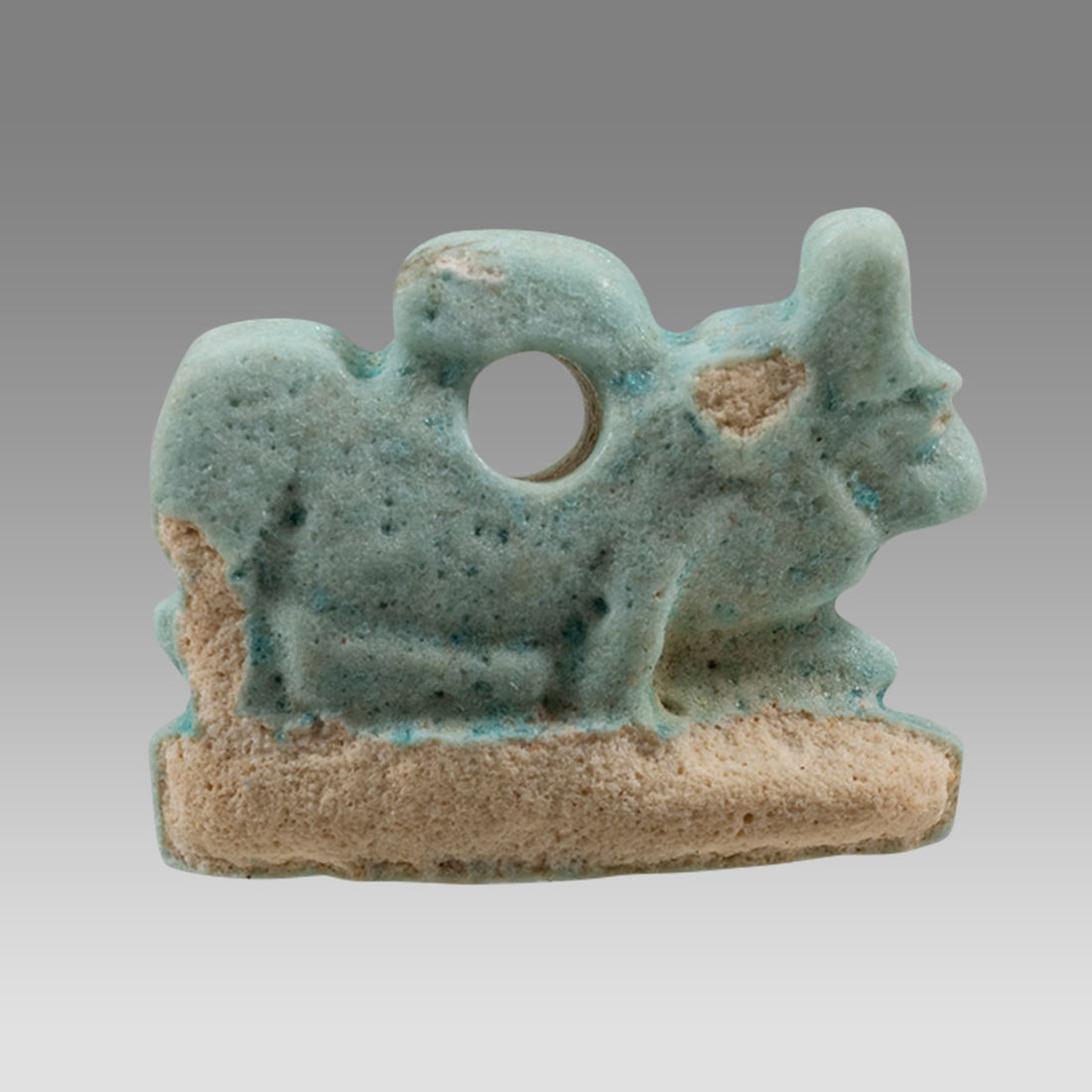 Ancient Egyptian Faience Apis Bull Amulet c.663-525 BC.: Ancient Egyptian Faience Apis Bull Amulet c.663-525 BC. Size 16 x 12 mm. Fine blue faience Apis Bull amulet, suspension hole at back. Provenance: Ex Secret Eyes Gallery New York 1970's-1980's