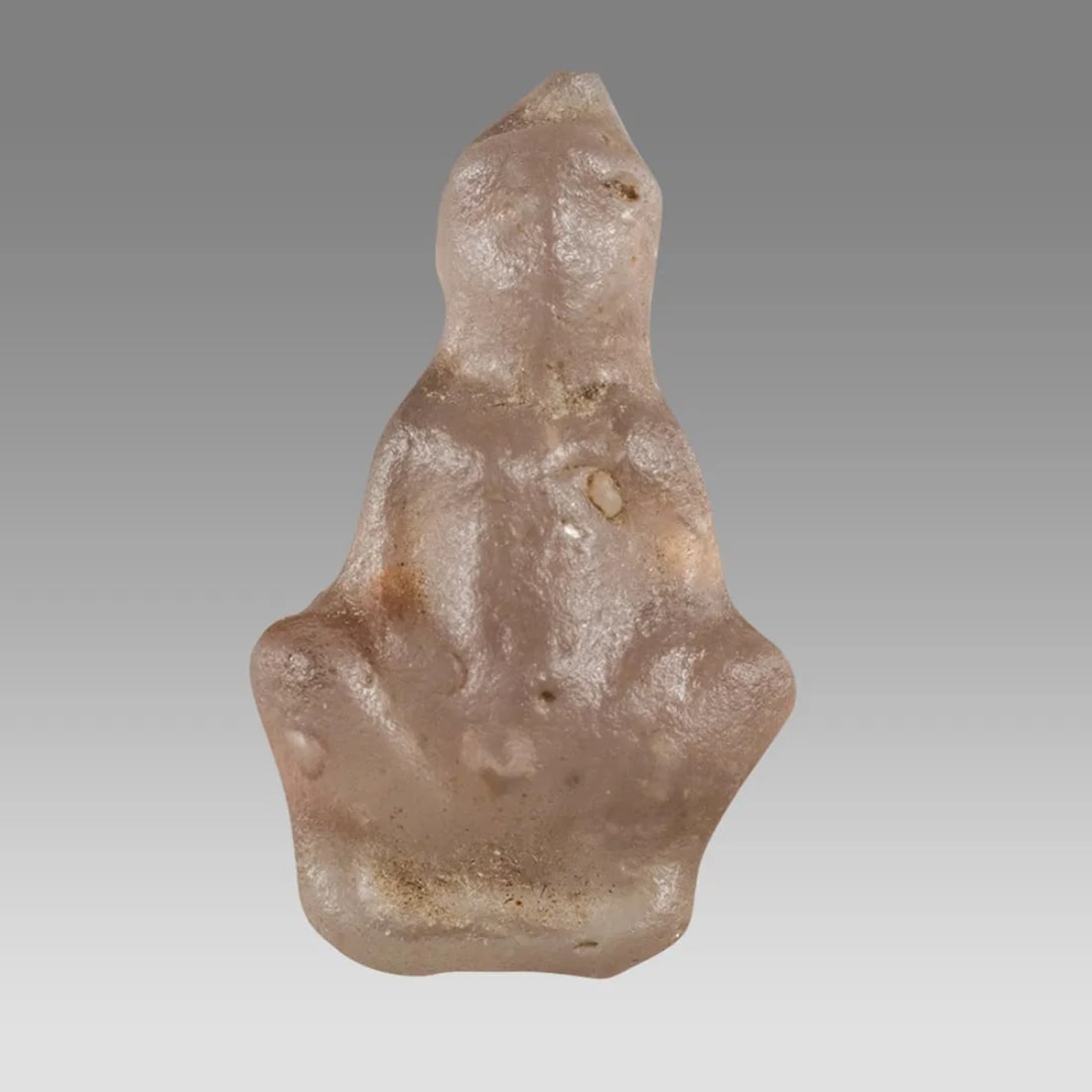 Ancient Egypt Ptolemaic Period Glass Amulet of Naked Baubo c.332-30 BC.: Ancient Egypt Ptolemaic Period Glass Amulet of Naked Baubo c.332-30 BC. Size 22 mm high. Small green glass of naked Baubo. a fun-loving bawdy jesting goddess. With suspension hole at head. similar sol