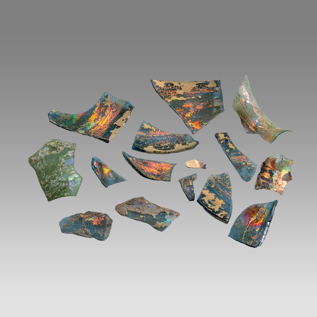 Lot of 14 Ancient Roman Green Glass Fragments c.2nd-4th century AD.: Lot of 14 Ancient Roman Green Glass Fragments c.2nd-4th century AD. Size 0 7/8 - 2 1/4 inches length. Beautiful green color glass fragment with nice patina. Would make nice jewelry as fragments. Prove