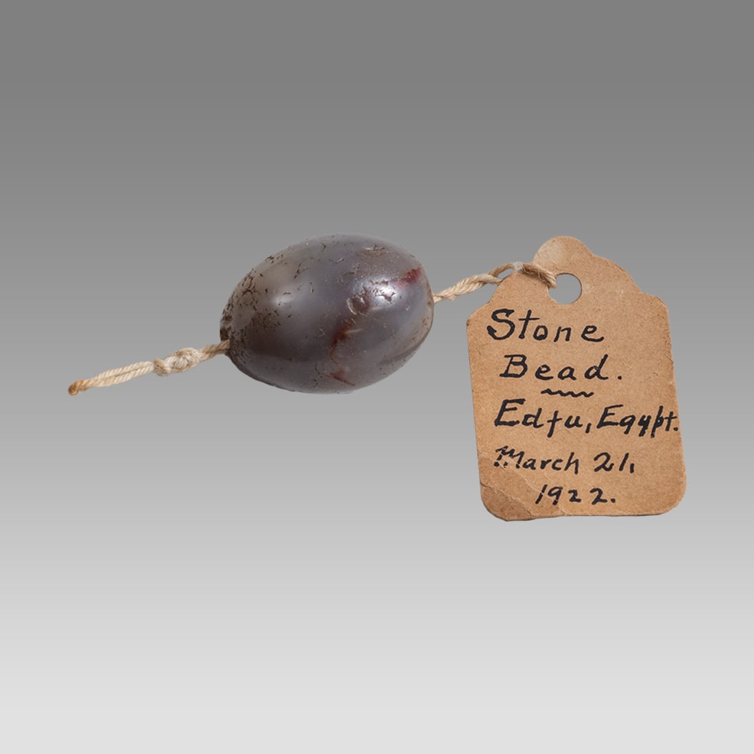 Ancient Egyptian Agate Bead c.2nd century BC. Pedgree 1922.: Ancient Egyptian Agate Bead c.2nd century BC. Pedgree 1922. Size 23 mm Weight 8.35 grams. Fine large gray agate bead. Provenance: Ex Stephen Siedel Collection, Phil, PA. With tag dated 1922.