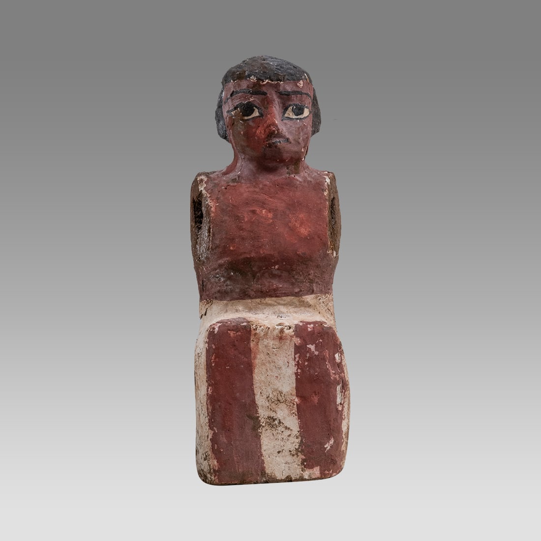 Ancient Egyptian Wooden Oarsman Tomb Figure. Egypt, Middle Kingdom, 2052-1778 BC.: Ancient Egyptian Wooden Oarsman Tomb Figure. Egypt, Middle Kingdom, 2052-1778 BC. Size 6.25 inches high. Painted wooden figure of seated rower wearing a white skirt (this figure would row the ship tra