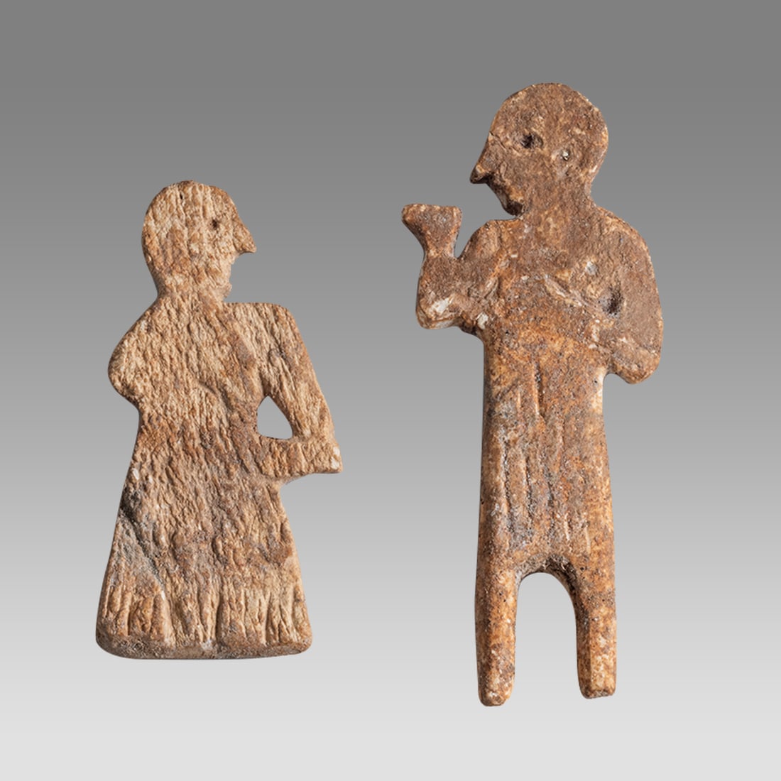 Lot of 2 Mesopotamian Bone Applique c.650 BC.: Lot of 2 Mesopotamian Bone Applique c.650 BC. Size 1 5/8 - 2 1/4 inches high. Carved bone applique depicting a standing man facing left. Provenance: Ex NYC Collection acquired in the USA Market 1990s