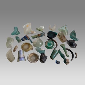 Lot of 25 pieces of Roman Glass Fragments, Rims, bases, necks handles and a broken glass bracelet.
