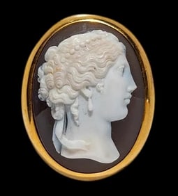A Neoclassical Gold and Sardonyx Cameo Brooch with a Portrait Head of a Goddess.