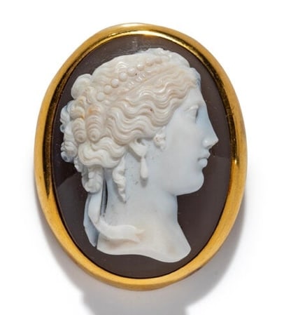 A Neoclassical Gold and Sardonyx Cameo Brooch with a Portrait Head of a Goddess.: A Neoclassical Gold and Sardonyx Cameo Brooch with a Portrait Head of a Goddess Probably Italy or France, Late 18th–Early 19th Century Height: 1 3/4 in. (4.45 cm) 18 karat gold Weight: 21.89 dwt (34