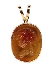 A Neoclassical Gold and Carnelian Pendant with a Male Portrait Head.