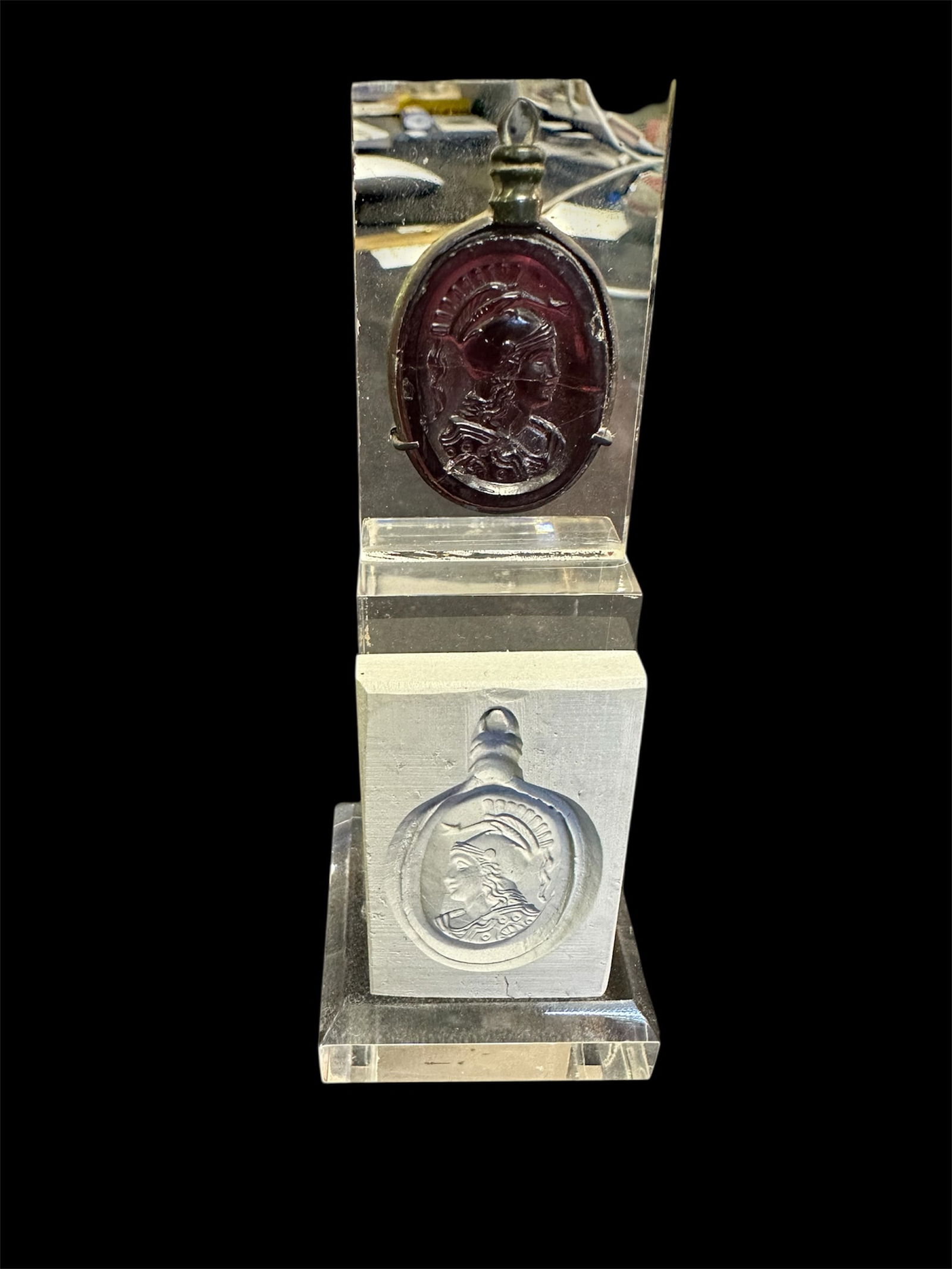 A Neoclassical Silver Pendant with Glass Intaglio of Bust of Athena.: A Neoclassical Silver Pendant with Glass Intaglio of the Bust of Athena Size: 28 x 22 mm Material: Silver with red glass intaglio Features: Large red glass intaglio depicting the bust of Athena, set w