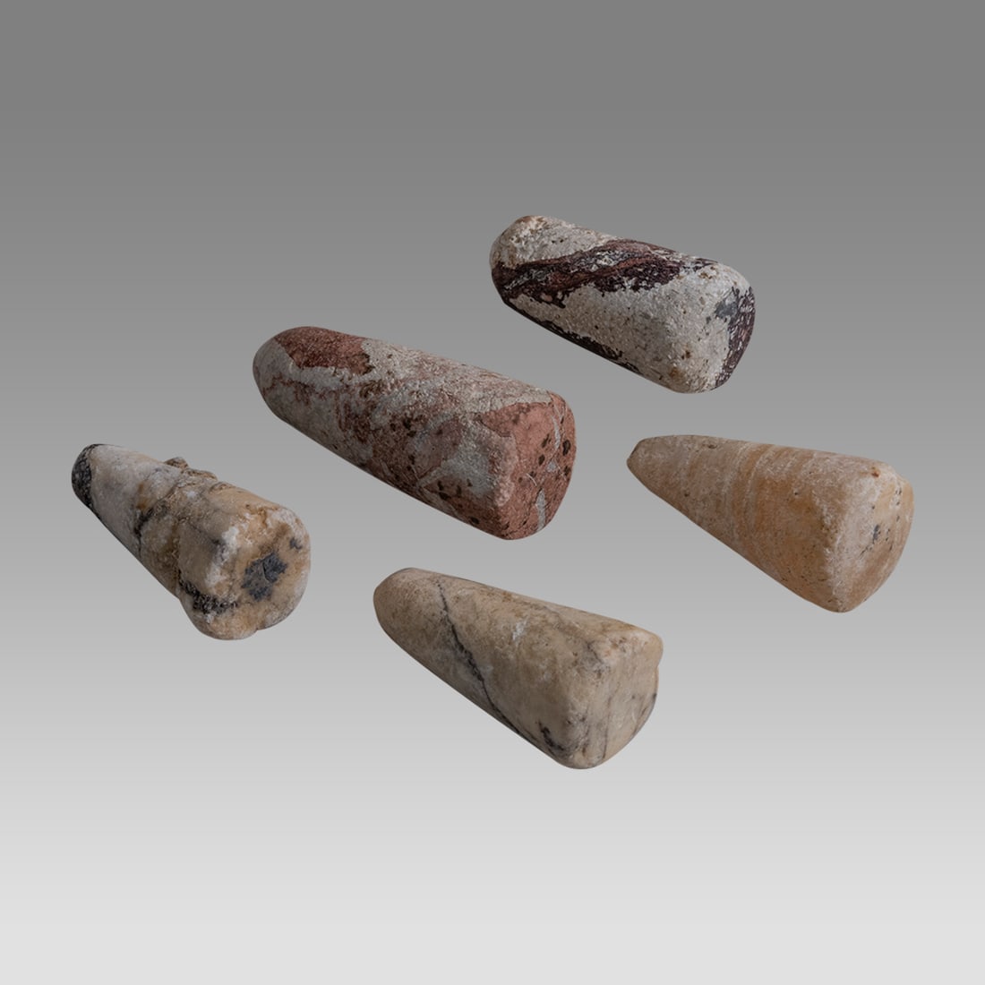 Lot of 5 Ancient Bactrian Stone Game Pieces c.3000-2000 BC.: Lot of 5 Ancient Bactrian Stone Game Pieces c.3000-2000 BC. Size 1 1/2 - 1 3/4 inches high. Unsual collection of 5 stone game pieces conical shape with flat base. Provenance: Private Collection Of Dal