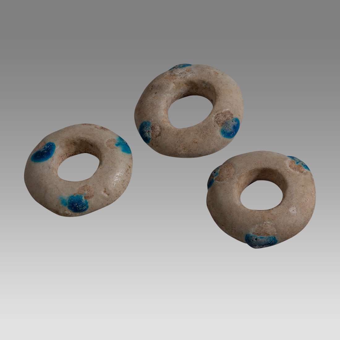 Lot of 3 Ancient Near East, Stone Rings c.3000-2000 BC.: Lot of 3 Ancient Near East, Stone Rings c.3000-2000 BC. Size 1 1/4 - 1 3/8 inch diameter. Lot of 3 stone rings with applied blue circular decoration. Provenance: Private Collection Of Dale McKeeby, CA