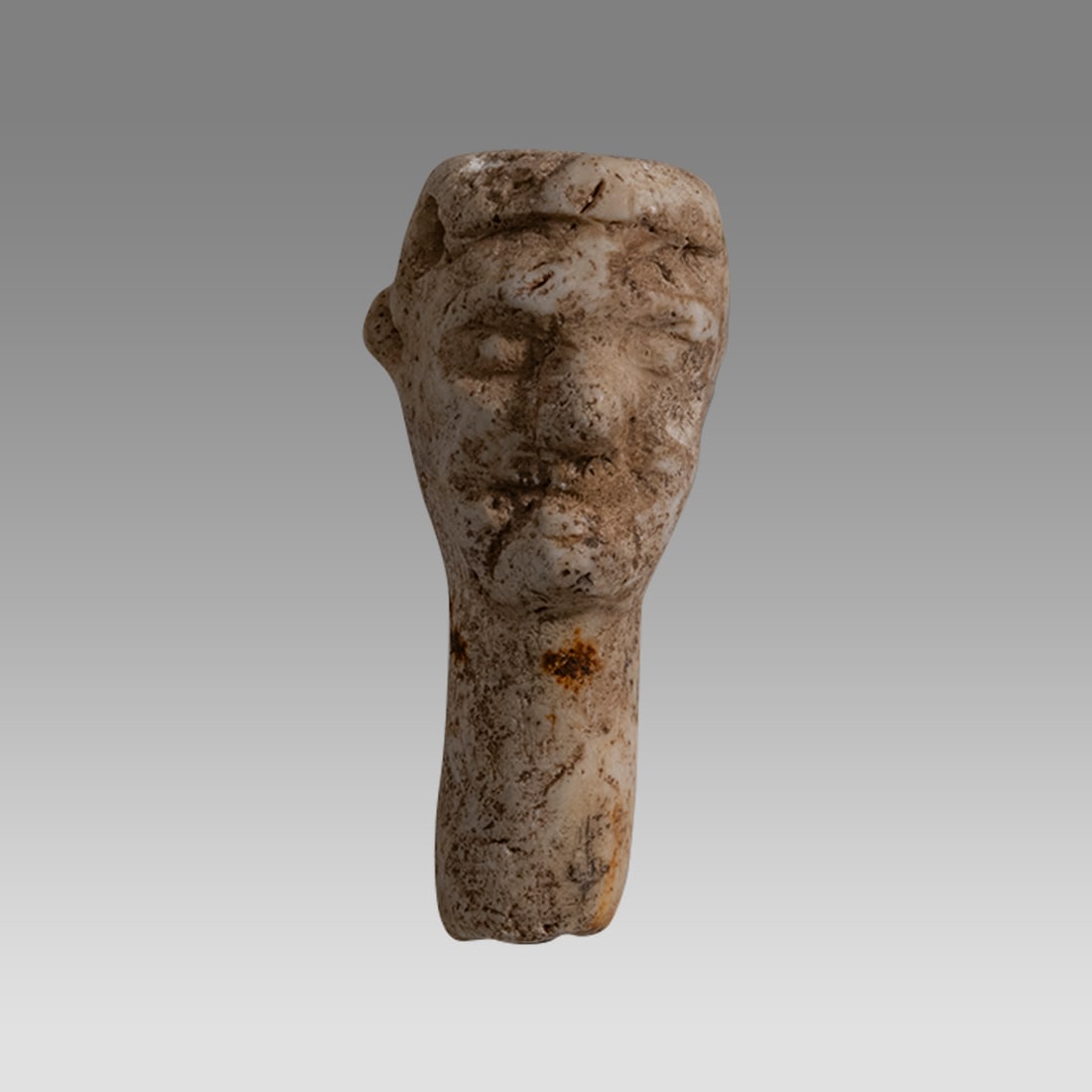Ancient Near East, Stone Head of Idol c.3000-2000 BC.: Ancient Near East, Stone Head of Idol c.3000-2000 BC. Size 1 7/8 inch high. Unusual stone head Idol with long neck that would be inserted into the body of the Idol. Pierced at top of head. Possibly An