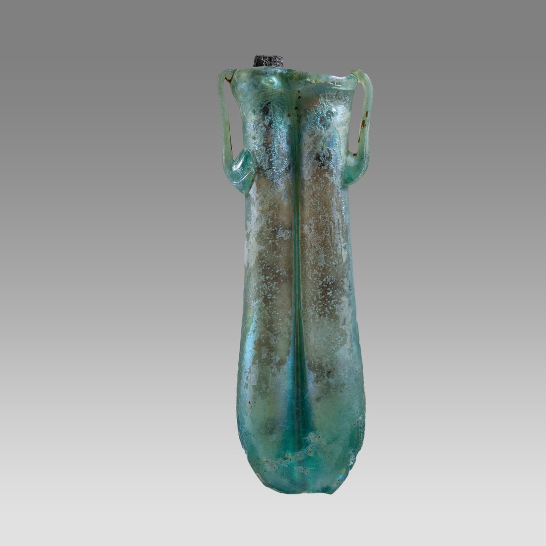 Ancient Roman Glass Unguentarium c.2nd century AD.: Ancient Roman Glass Unguentarium c.2nd century AD. Size 4 3/4 inches high. + stand. double tube with twin handles vessel. lovely patina. Custom mounted. Provenance: Ex NYC Collection acquired in the U