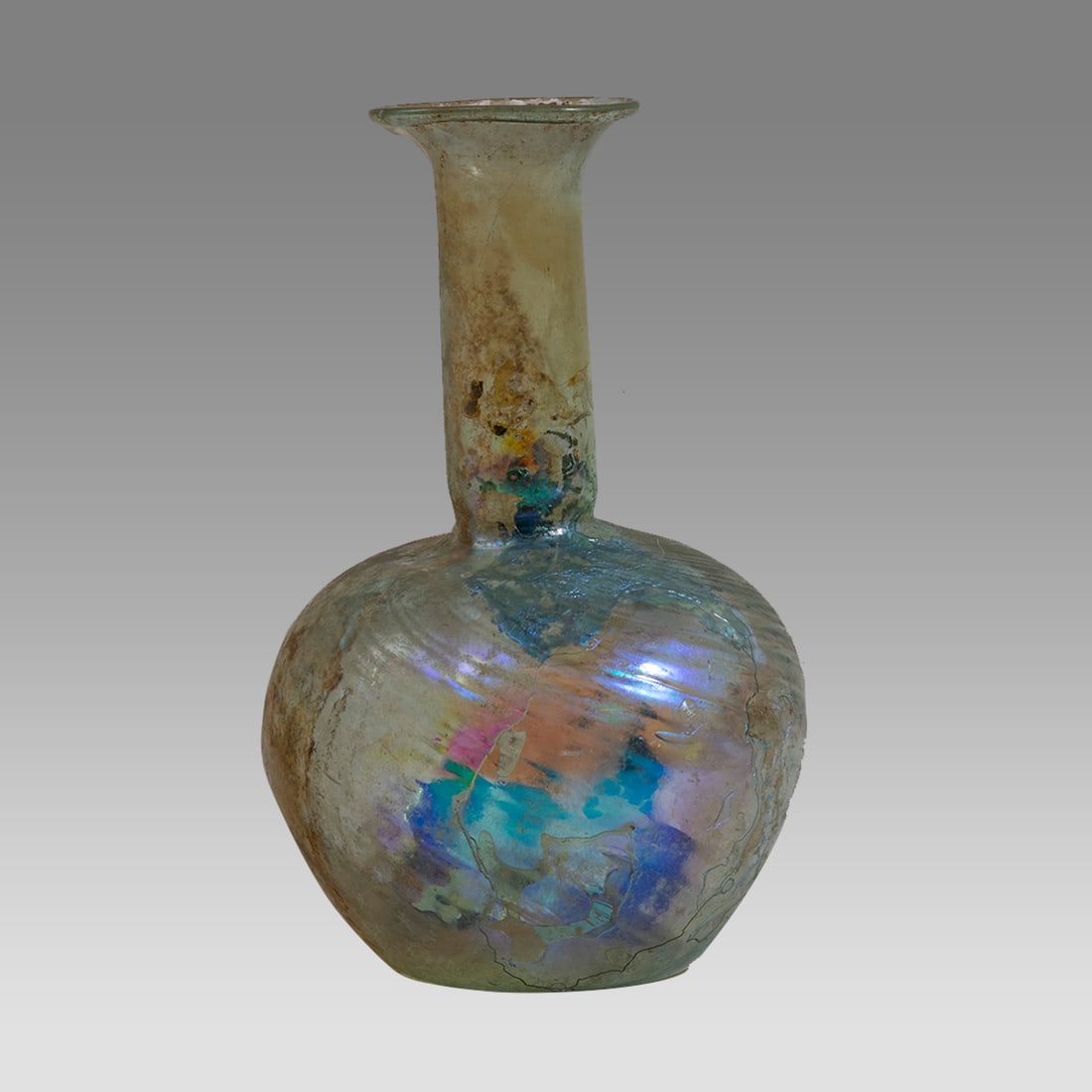 Ancient Roman Large Glass Bottle c.2nd century AD.: Ancient Roman Large Glass Bottle c.2nd century AD. Size 8 5/8 inches high. 4 1/2 inches diameter widest point. Large Roman patina Glass bottle with bulbous ribbed body and tall neck with flared rim. l