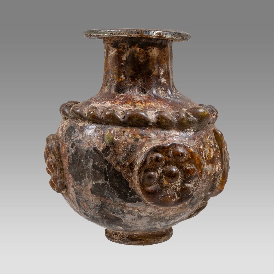 Ancient Sasanian Glass Bottle With Floral Applique c.5th century AD.: Ancient Sasanian Glass Bottle With Floral Applique c.5th century AD. Size 3 1/4 inches high. A rare Sasainian Glass bottle with floral applique around, snake between. Rare and unique example. Provenan