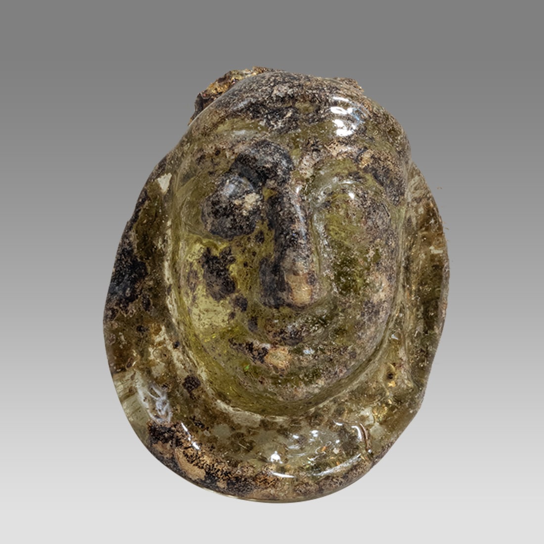 Ancient Roman Glass Bust Applique c.2nd-3rd century AD.: Ancient Roman Glass Bust Applique c.2nd-3rd century AD. Size 1 1/4 inches high. Ancient Roman applique depicting a bust of a youth, fragment from a vessel. Provenance: Ex NYC Collection acquired in th