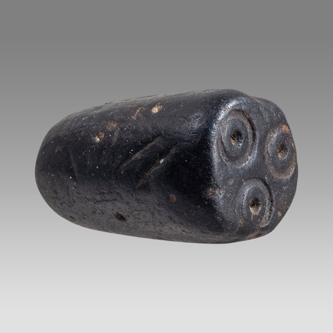 Ancient Mesopotamian Early Dynastic Stone Stamp Seal.: Ancient Mesopotamian Early Dynastic Stone Stamp Seal. Size 1 inch length. Carved black stone stamp seal with 3 circular design. Provenance: From A Private East coast collection acquired in the USA Mar