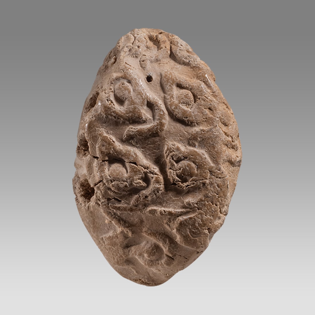 Mesopotamian Style Clay Bullae.: Mesopotamian Style Clay Bullae. Size 1 1/4 inch length. A small clay Bullae with impression seal on all sides. Suspension holes at top. Age unknown. Provenance: From A Private East coast collection ac