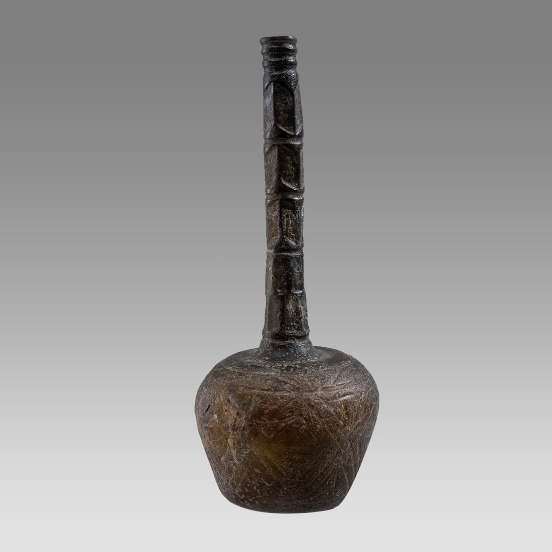 Ancient Islamic Cut Green Glass Rose Water Bottle c.10th century AD.: Ancient Islamic Cut Green Glass Rose Water Bottle c.10th century AD. Size 7 3/4 inches high. Unusual dark green cut glass bottle with etched geometric design. Provenance: Ex Private NYC Collection acq