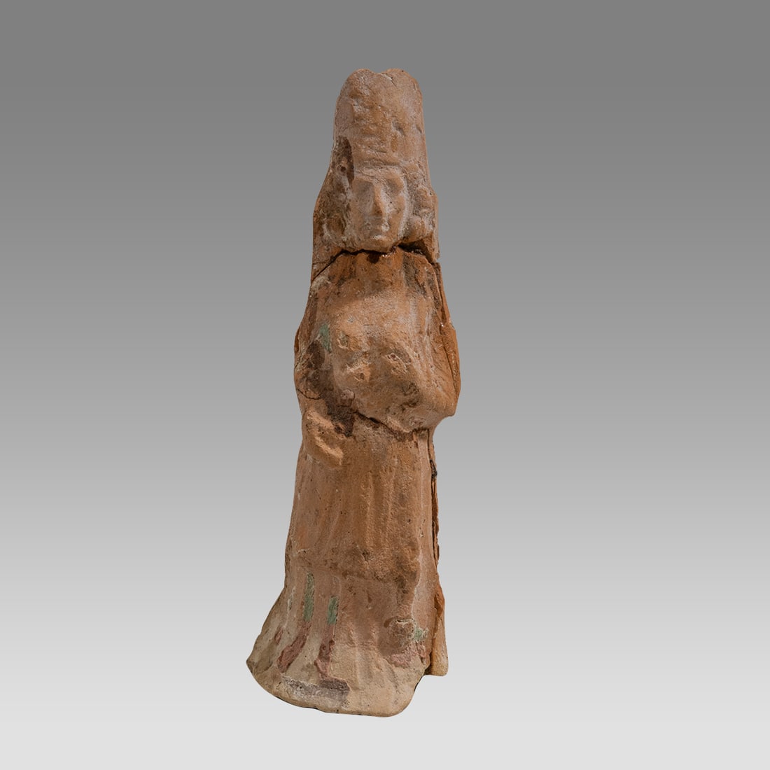 Ancient Mesopotamian Terracotta Goddess holding left breast c.650 BC.: Terra Cotta Goddess holding left breast – Roman? Someone has suggested it represents the goddess Tyche. Hollow. Interesting detail to face and draped gown pattern at bottom. From the collection of F