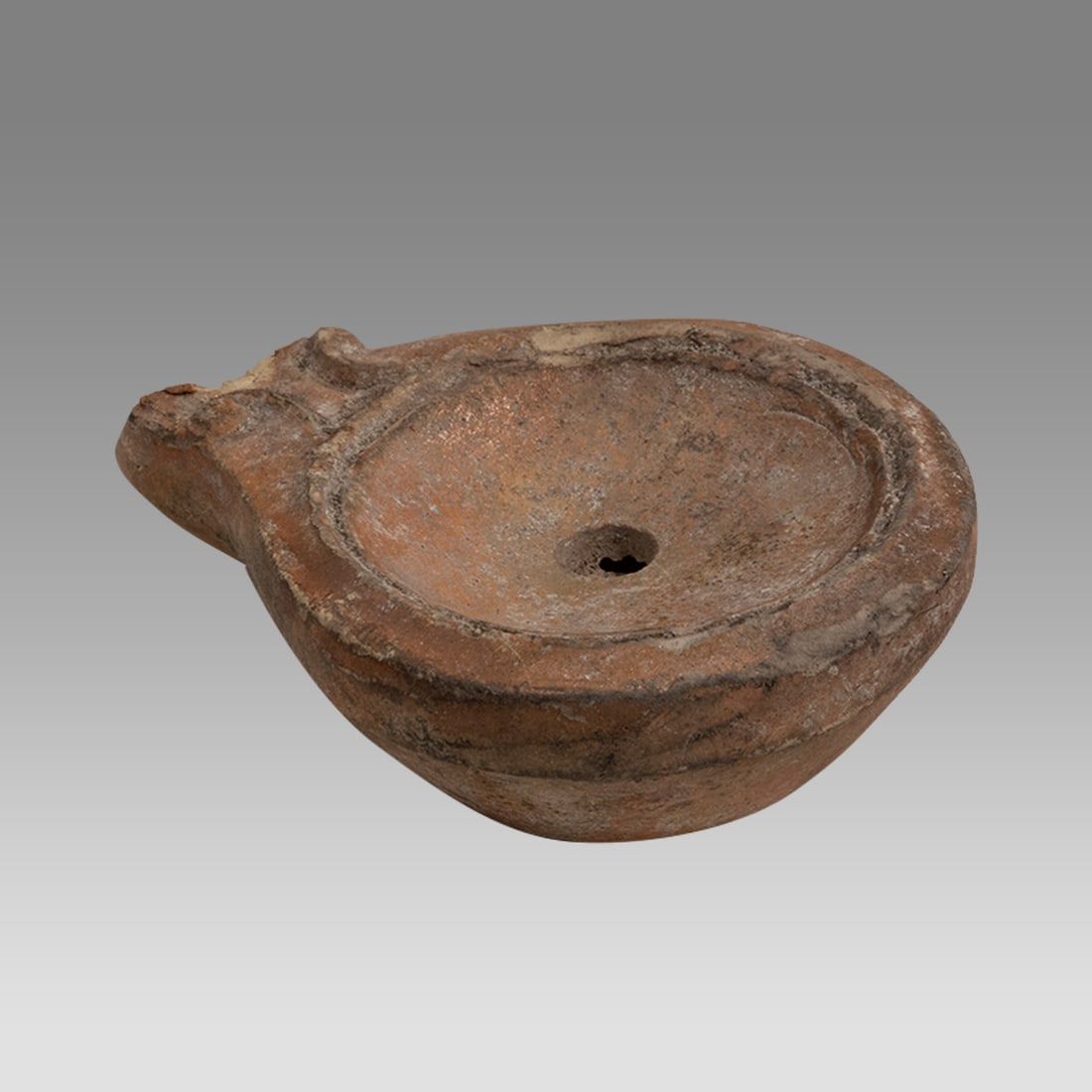 Roman Terracotta Oil Lamp with Maker’s Mark. STROBIL. c.2nd century AD.: Terra Cotta Oil Lamp with Maker’s Mark. STROBIL. Size 2 3/4 inches length. What makes this lamp special is the maker’s mark which is the mark for a lamp manufacturer named “STROBILIS” who 
