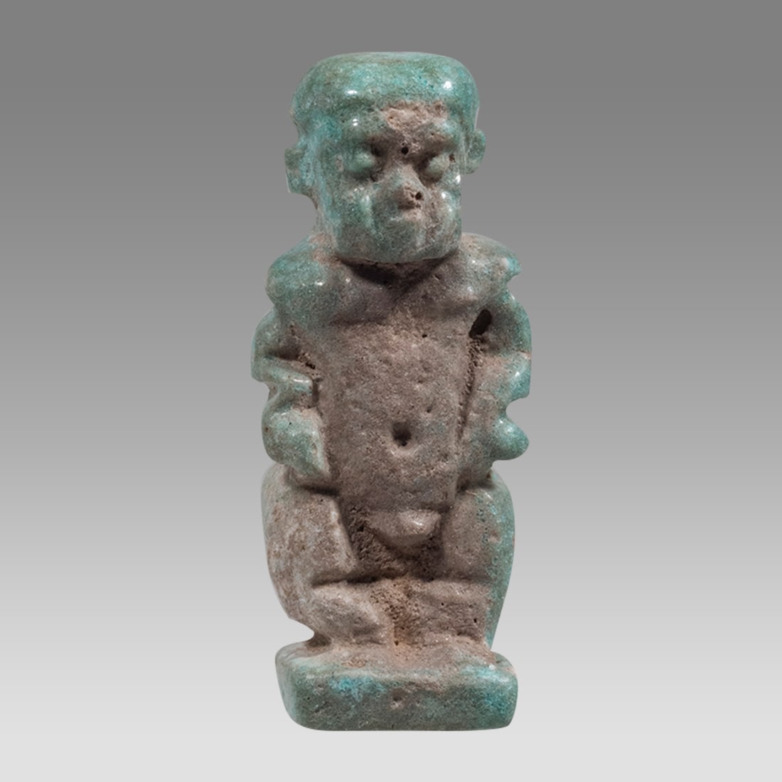 Ancient Egyptian Faience Amulet Of Dwarf Pataikos LATE PERIOD CIRCA 664-332 B.C.: Ancient Egyptian Faience Amulet Of Dwarf Pataikos LATE PERIOD CIRCA 664-332 B.C. Size 1 inch high. Light blue glazed faience Amulet of Dwarf Pataikos, Suspension hole at back. Provenance: Private coll