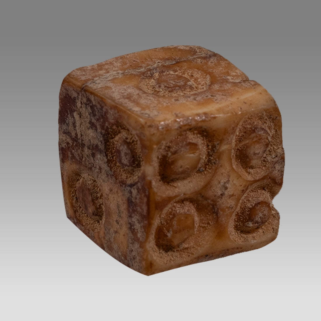 Ancient Roman Carved Bone Dice c.1st-2nd century AD.: Ancient Roman Carved Bone Dice c.1st-2nd century AD. Size 12 mm. Fine carved bone single dice with circular numbers on each side. Provenance: Private collection, bought via London Art Market previousl