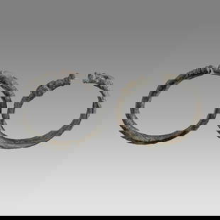 Ancient Roman Bronze Bracelets c.2nd century AD.(2): Ancient Roman Bronze Bracelets c.2nd century AD.(2) Size 2 5/8 - 2 1/2 inches diameter. Lot of 2 Ancient Bronze Bracelets one snake form and the other with animal heads terminal, choice patina. Proven