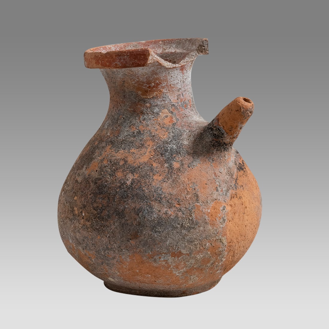 Ancient Roman Holyland Terracotta Pitcher c.1st-4th century AD.: Ancient Roman Holyland Terracotta Pitcher c.1st-4th century AD. Size 5 3/4 inches high. Thick walled red terracotta pitcher with ring base, small spout at shoulder, strainer at neck. Provenance: Priva