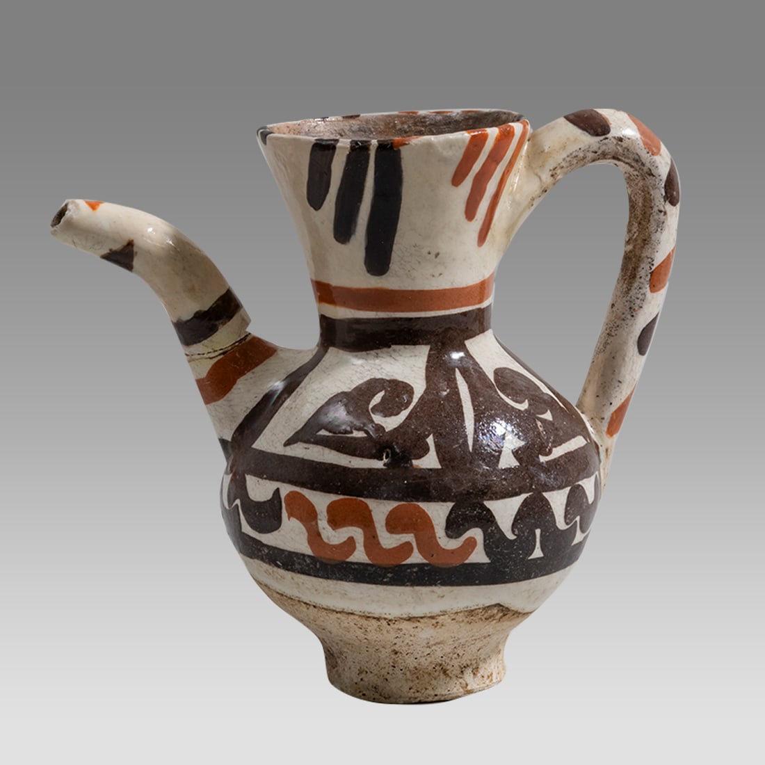 Islamic Ceramic Small Ewer with Floral design.: Islamic Ceramic Small Ewer with Floral design. Size 4 7/8 inches high. Fine white ceramic footed ewer with balck and red floral design. Provenance: Private collection, bought via London Art Market pre