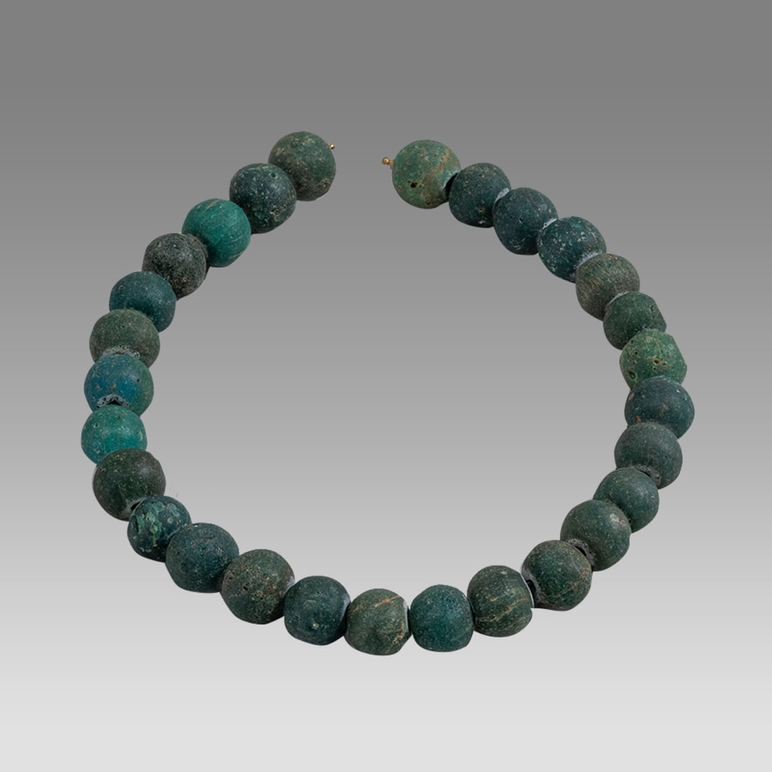 Indonesian, Green Glass Bead Necklace.: Indonesian, Green Glass Bead Necklace Possibly ancient c.6th-9th century AD. Size 17 inches length, bead size 15-16 mm. Unusual green glass bead necklace.