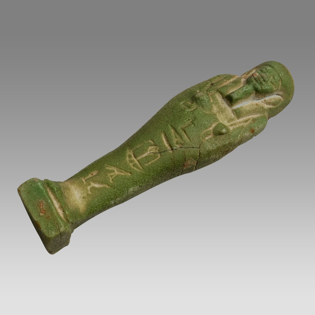 Ancient Egyptian Green Faience Ushabti. Egypt, XXVI Dynasty, 664-525 BC.: Ancient Egyptian Green Faience Ushabti. Egypt, XXVI Dynasty, 664-525 BC. Size 3 5/8 inches high. Fine green glazed faience mummiform figure, bearded holding crook and flail. Hieroglyph text on front a