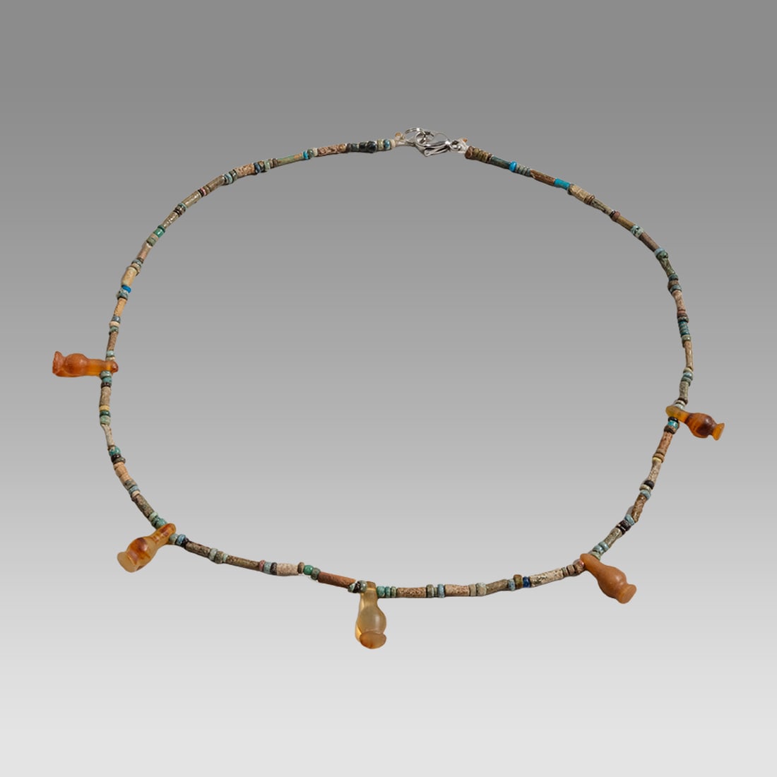 Ancient Egyptian Faience, Necklace c.300-50 BC.: Ancient Egyptian Faience, Necklace c.300-50 BC. Size 17 inches length. Great Looking single strand Faience Bead necklace, mixed with later period Carnelian amphora form amulets. wearable. Provenance:
