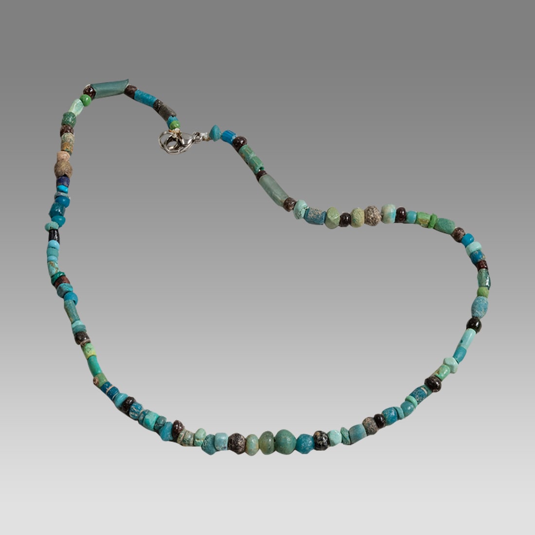 Ancient Roman Glass Bead Necklace c.2nd century AD.: Ancient Roman Glass Bead Necklace c.2nd century AD. Size 16 1/4 inches length. Great Looking single strand Roman blue Glass Bead necklace. wearable. Provenance: Ex Secret Eyes Gallery New York 1970's-