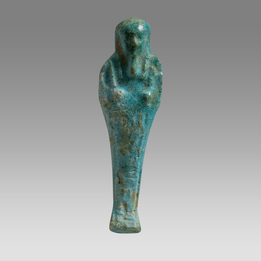 Ancient Egyptian Faience Ushabti Figure Late period, ca. 700-300 B.C.: Ancient Egyptian Faience Ushabti Figure Late period, ca. 700-300 B.C.Size: 4 3/4 Inches high. 1 1/2 inch wide. A molded faience ushabti having a mottled blue glazed surface. Depicted wearing the stria