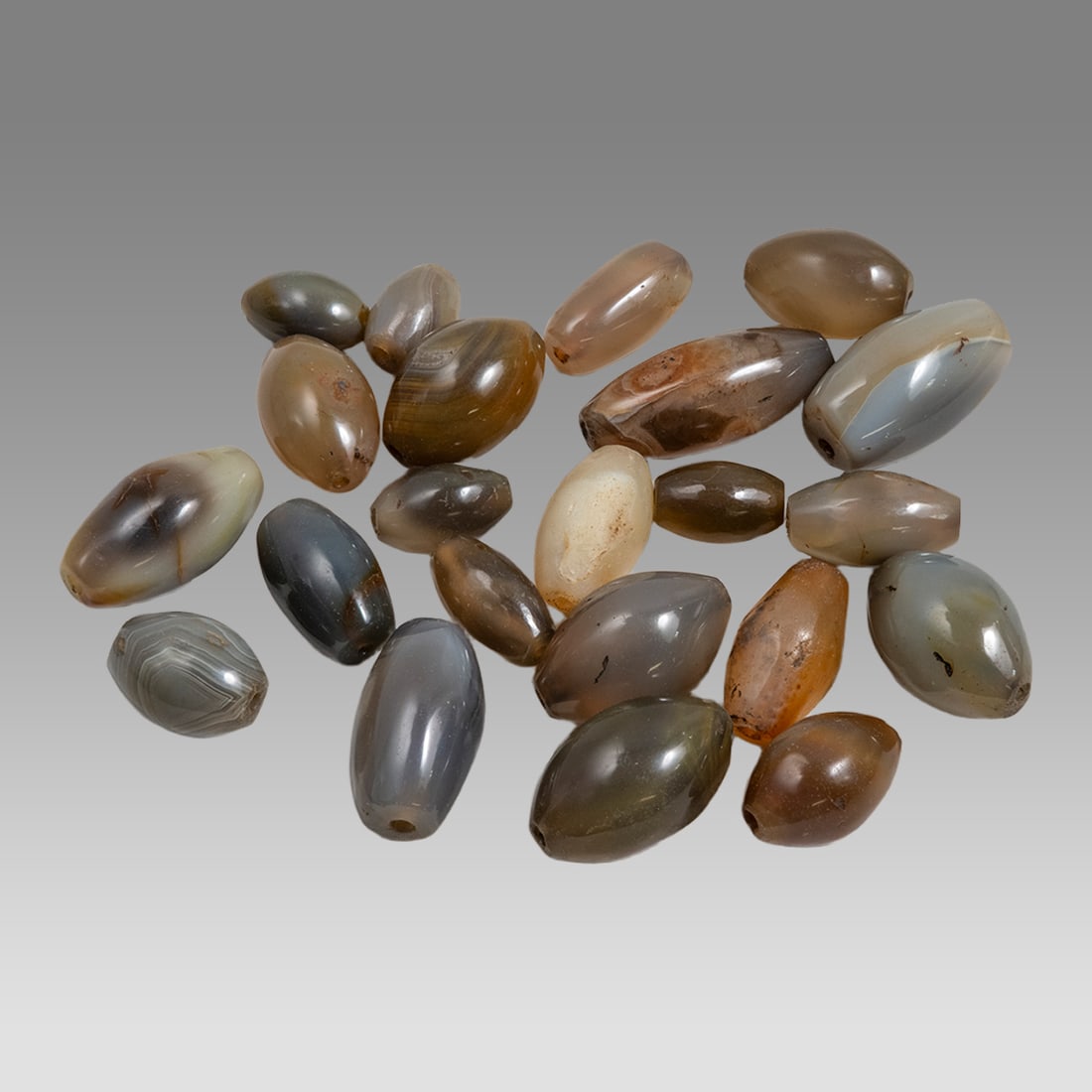 Lot of 22 Agate Beads.: Lot of 22 Agate Beads. Size 18-34 mm. Lot of 22 Agate beads with hole through for suspension. Polished Age unknown. Ex Silk Road NYC.