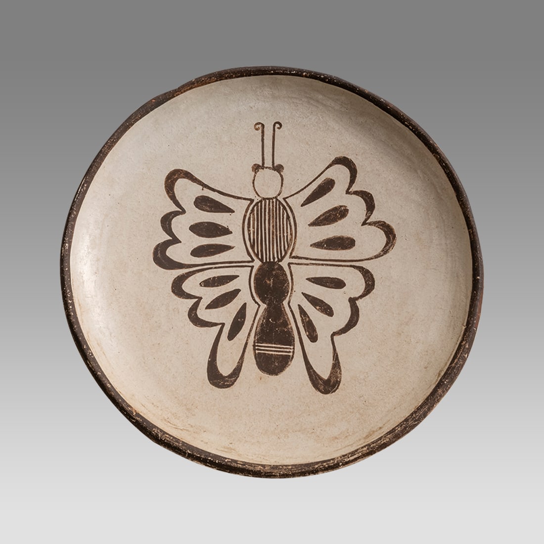 ACOMA Pottery Sky City Butterfly Plate Black Polychrome, Signed.: ACOMA Pottery Sky City Butterfly Plate Black Polychrome, Signed. Size 5 3/4 inches diameter. o 3/4 inch high. Fine butterfly decorated shallow plate, signed. Provenance: Ex John Benson Estate 1960s Ne