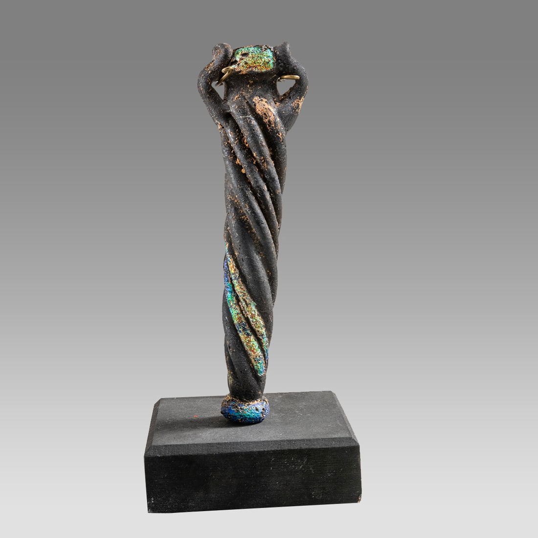 Ancient Roman Swirl Decorated Glass Vial, Ca. 1st - 2nd century A.D,: Ancient Roman Swirl Decorated Glass Vial, Ca. 1st - 2nd century A.D, Size 4 7/8 inches High. opaque black paste glass vial having an overall spiral twist decoration, applied opposing handles below the