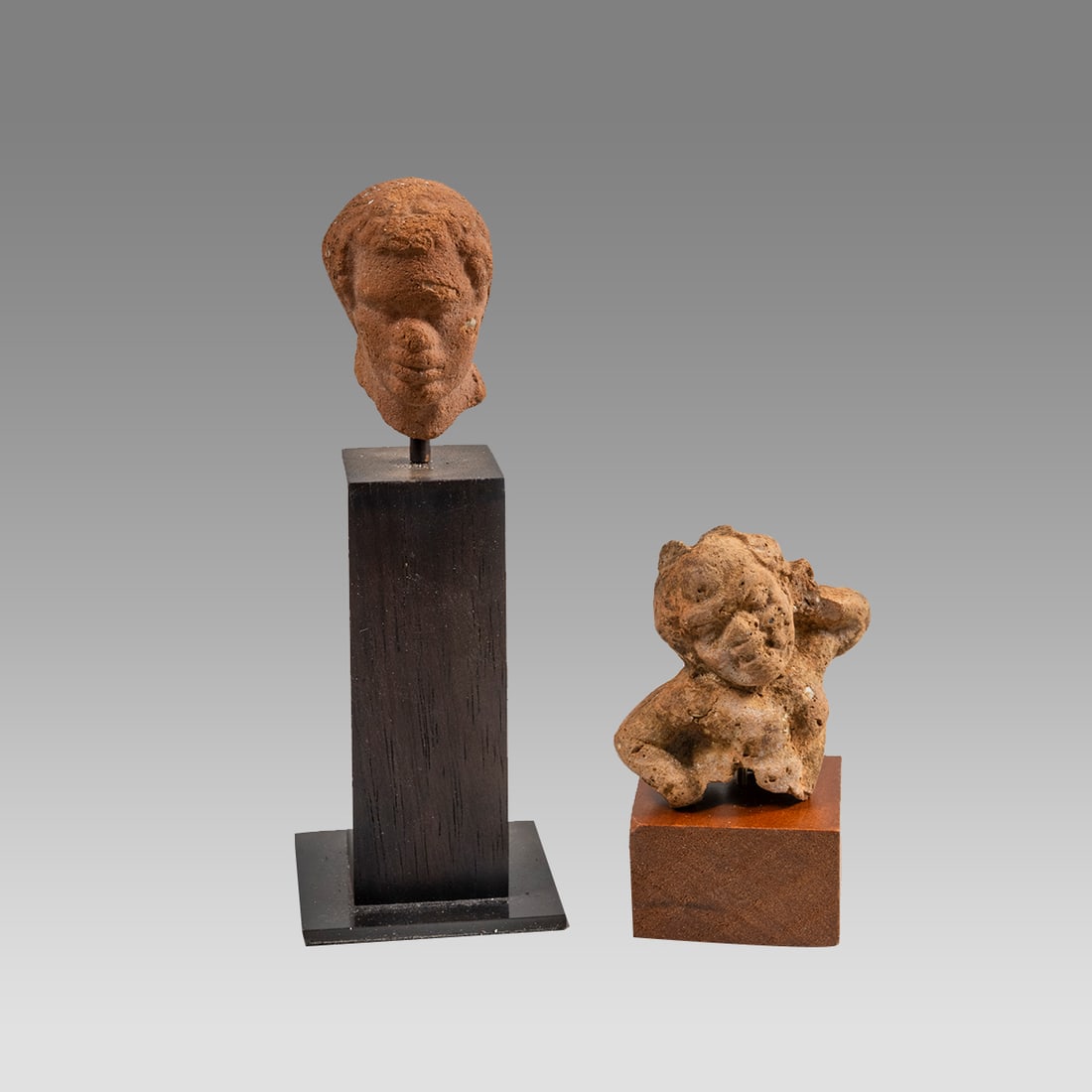 Lot of 2 Ancient Africans/Nubians Terracotta, Ptolemaic on custom stand, 3rd-1st C BCE.: Lot of 2 Ancient Africans/Nubians Terracotta, Ptolemaic on custom stand, 3rd-1st C BCE. Size 35x33x25mm, intact and desirable Note: Julia dated to Ptolemaic by the well-crafted eyes (they aren’t “