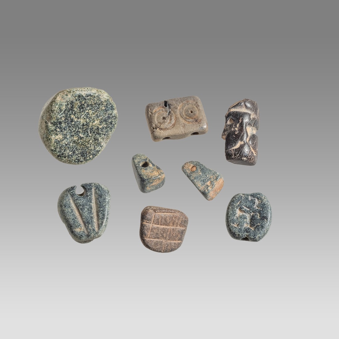 Lot of 8 Ancient Mesopotamian Stone Seals c.3000 BC.: Lot of 8 Ancient Mesopotamian Stone Seals c.3000 BC. Size 13-27 mm. A collection of 8 mesopotamian Early Dynastic black stone seals. Provenance: Ex Florida collection acquired in the USA Market.