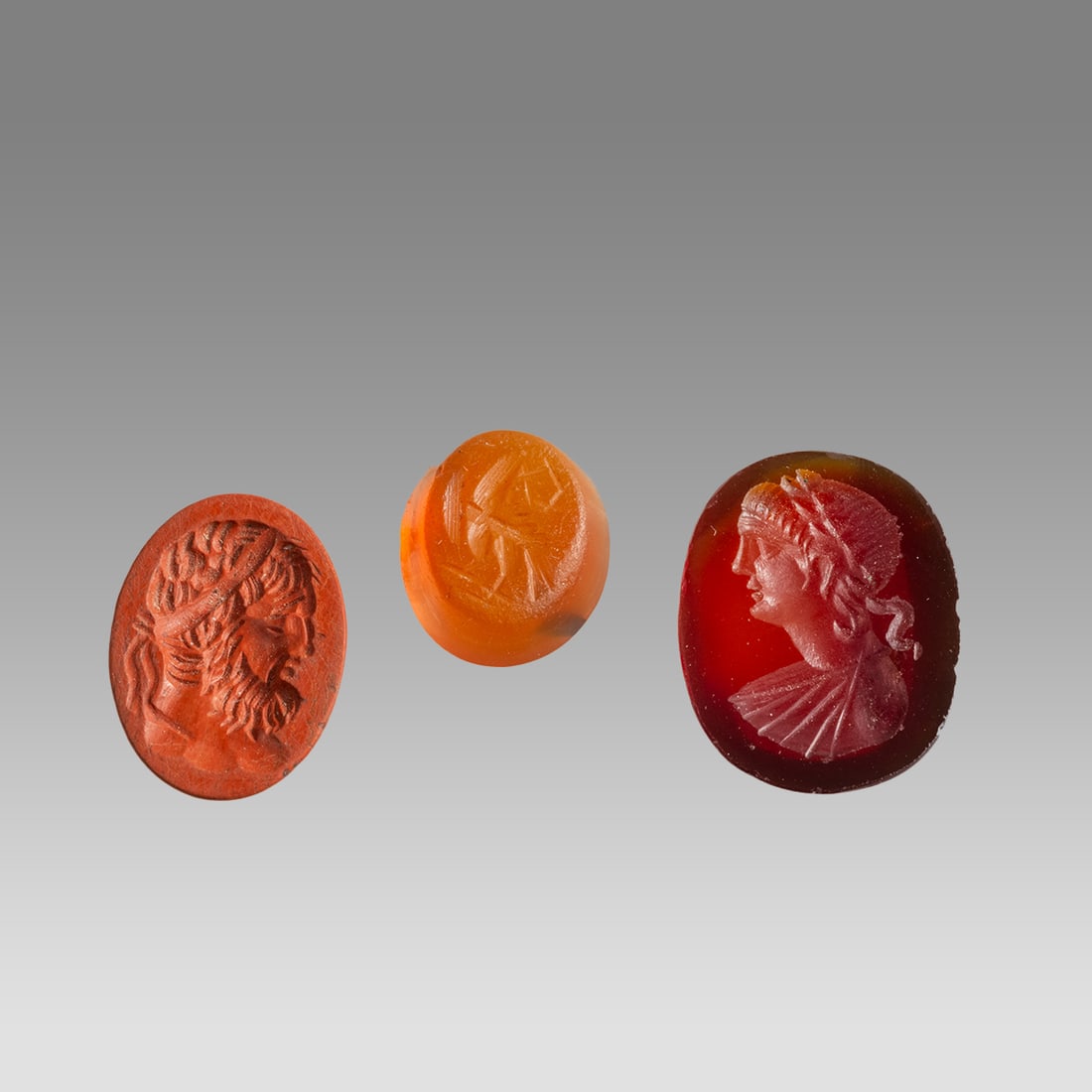 Lot of 3 Roman Style Red Jasper, Carnelian Intaglios.: Lot of 3 Roman Style Red Jasper, Carnelian Intaglios. Size 13-18 mm. Carved modern stone intaglios. Modern not ancient. Provenance: Ex Florida collection acquired in the USA Market.