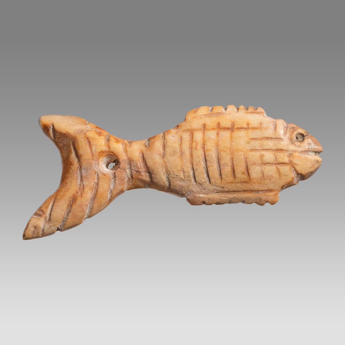 Ancient Egyptian Coptic Bone Fish c.3rd-5th century AD.: Ancient Egyptian Coptic Bone Fish c.3rd-5th century AD. Size 1 3/4 inches length. Fine carved fish with suspension hole at tail. Great details and quality. Provenance: Private Florida collection. Acqu
