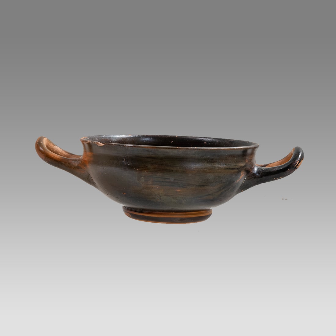 Ancient Greek Magna Graceia Apulian Pottery Kylix c.4th century BC.: Ancient Greek Magna Graceia Apulian Pottery Kylix c.4th century BC. Size 6 3/4 inches length across handle spam, 2 inches high. Fine Apulian pottery kylox with twin handles. Provenance: Ex Private Flo
