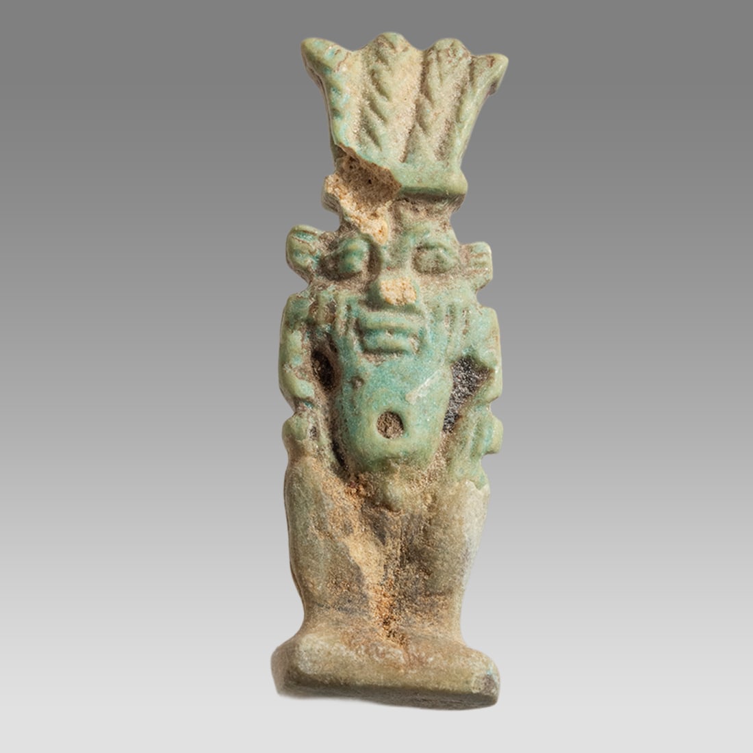 Ancient Egyptian Faience Amulet Of Bes c.664-332 BC.: Ancient Egyptian Faience Amulet Of Bes c.664-332 BC. Size 1 1/4 inch high. Fine green faience amulet of Bes depicted standing wearing feather crown. Suspension hole through the crown. Provenance: Priv