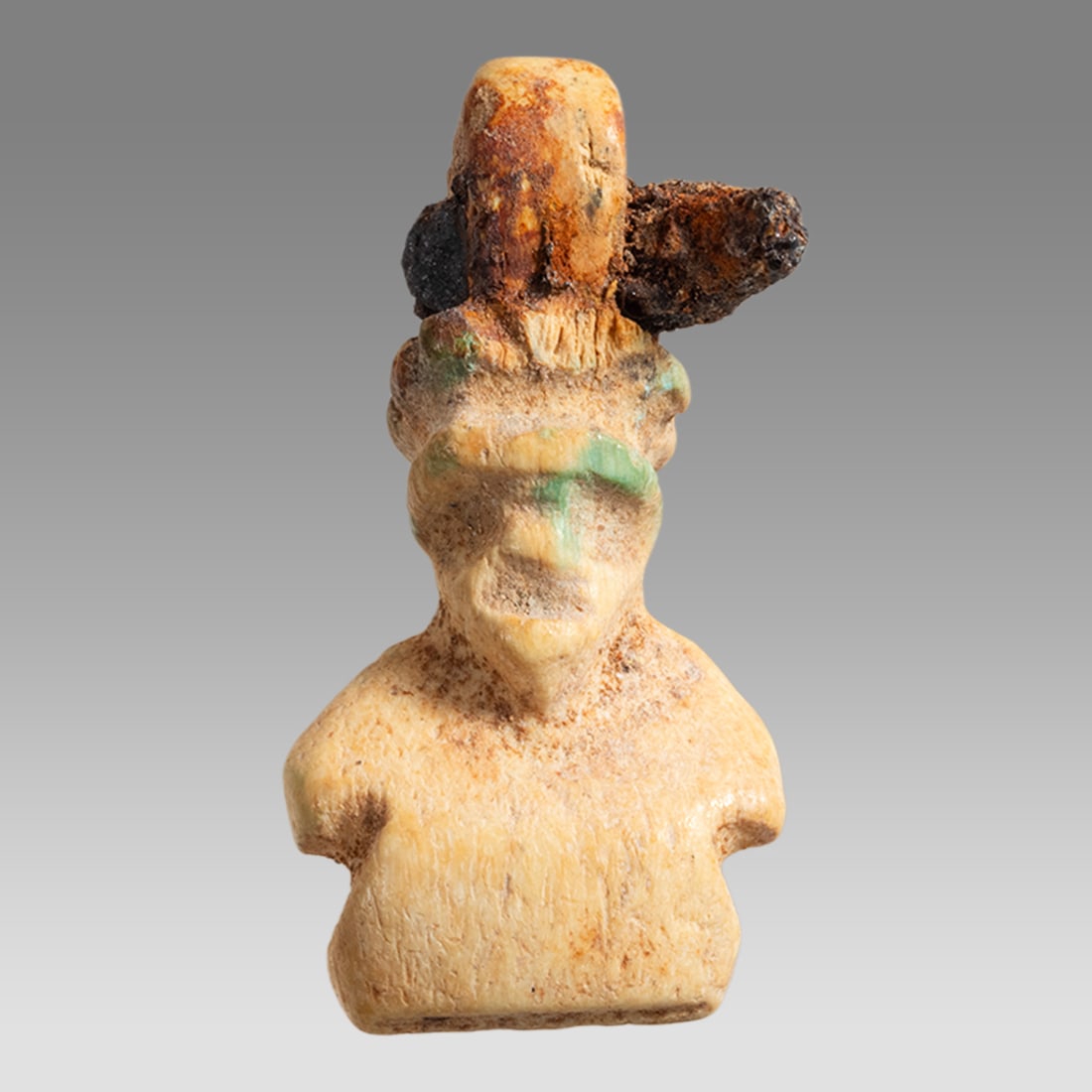 Ancient Roman Bone Amulet Bust of Man c.2nd century AD.: Ancient Roman Bone Amulet Bust of Man c.2nd century AD. Size 26 x 13 mm. Ancient Roman carved bone bust of a man with suspension loop. Iron pin stuck through the suspension as seen. Provenance: Privat