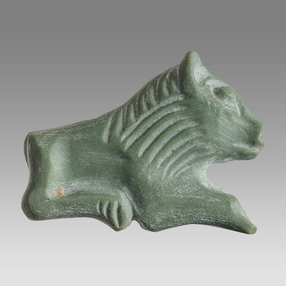 Mesopotamian Style Green Stone Lion Amulet.: Mesopotamian Style Green Stone Lion Amulet. Size 22 x 16 mm. Carved green stone lion amulet. Not ancient. Private collection, bought via London art market, formerly in a 1970s/80s Swiss collection.